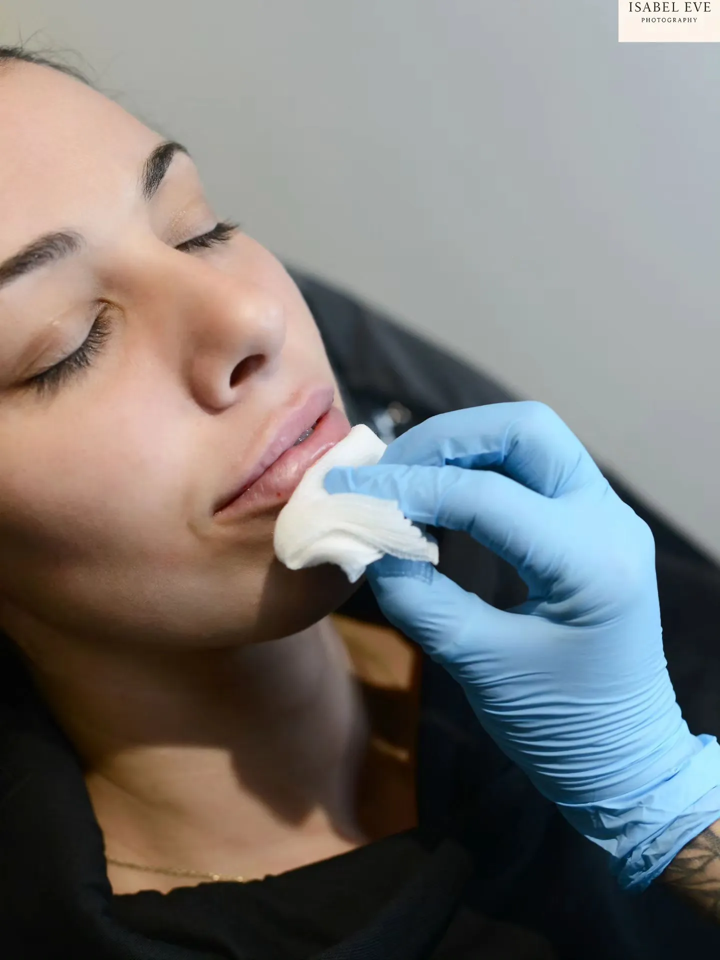 A woman getting her teeth brushed by a dentist.
